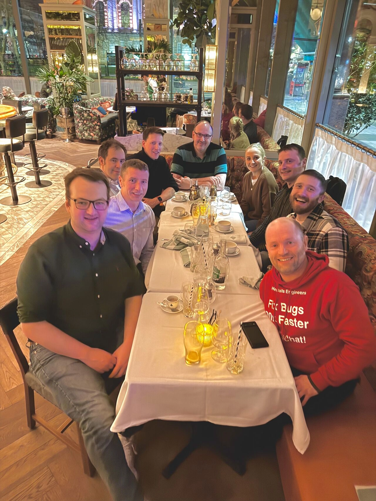 Nine people sitting around a table